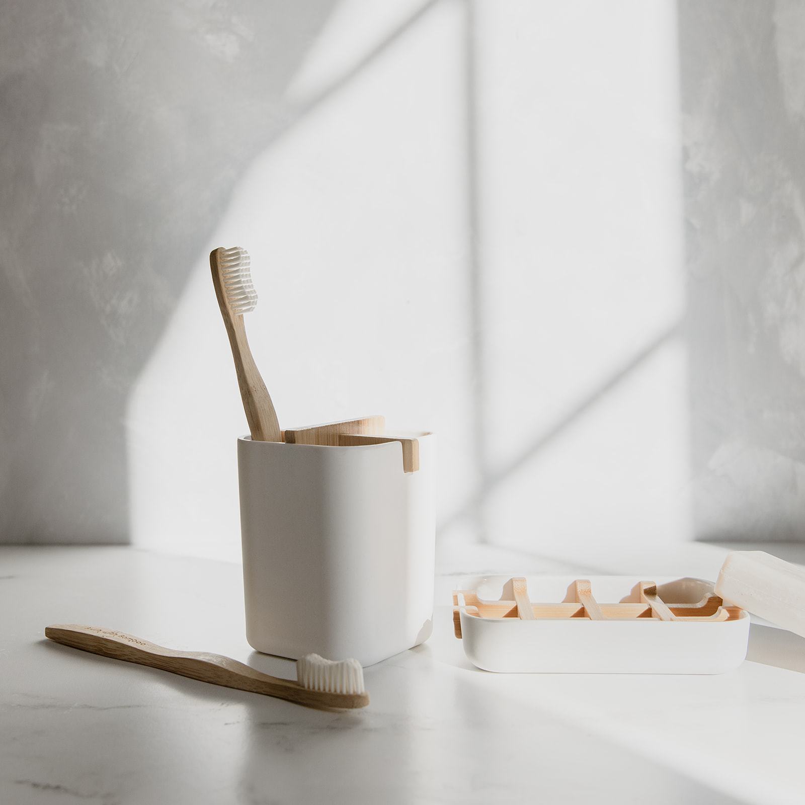 Bamboo toothbrush from ZeroWasteStore.com with a natural bamboo handle and soft bristles, eco-friendly dental care product.