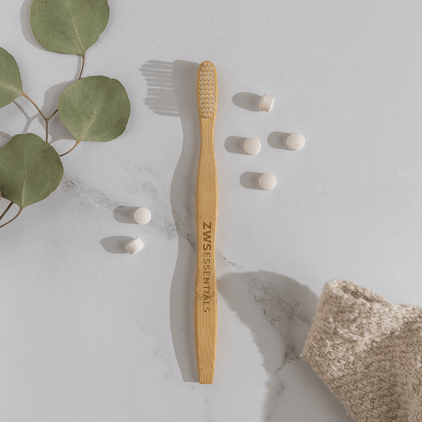 Bamboo toothbrush from ZeroWasteStore.com with natural bamboo handle and soft bristles, eco-friendly dental care product.