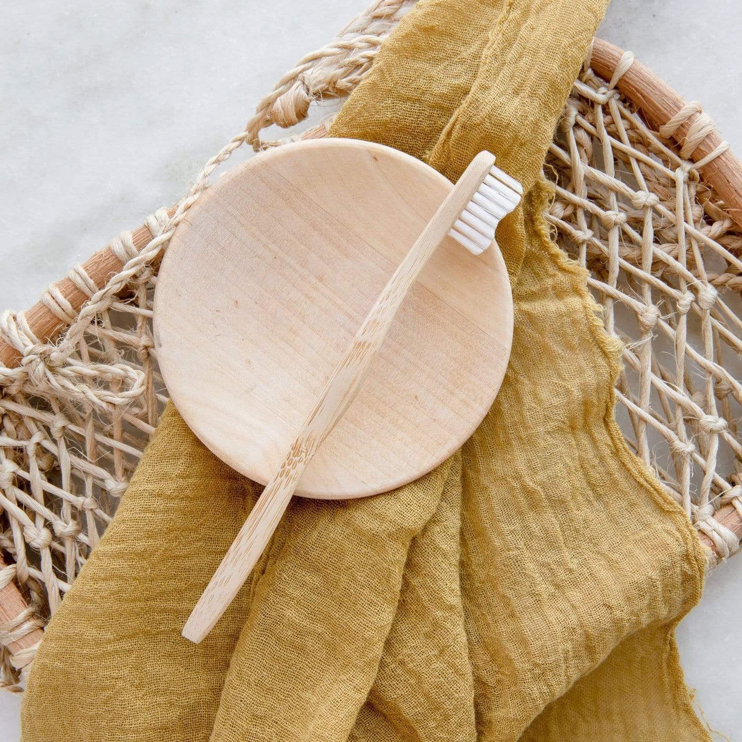 Child's bamboo toothbrush from ZeroWasteStore.com with a green handle and soft bristles, eco-friendly dental care for kids.
